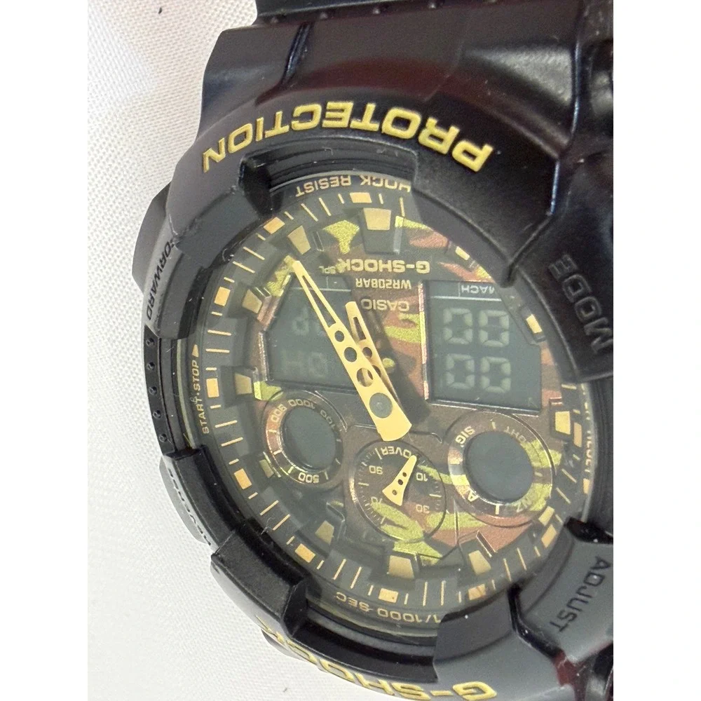 Casio G-Shock GA-100CF Black Gold Camo Dial Resin Mens Watch 5081